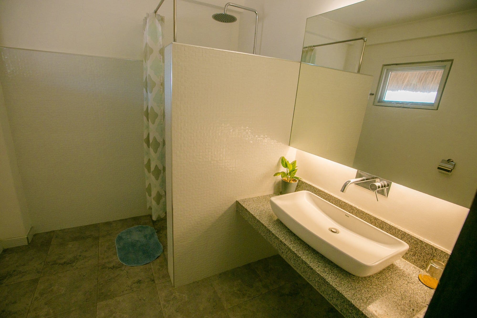 Walk-in shower and granite vanity in the Deluxe bathroom