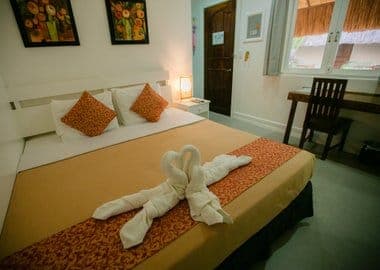 Superior Room with king bed and warm orange accents